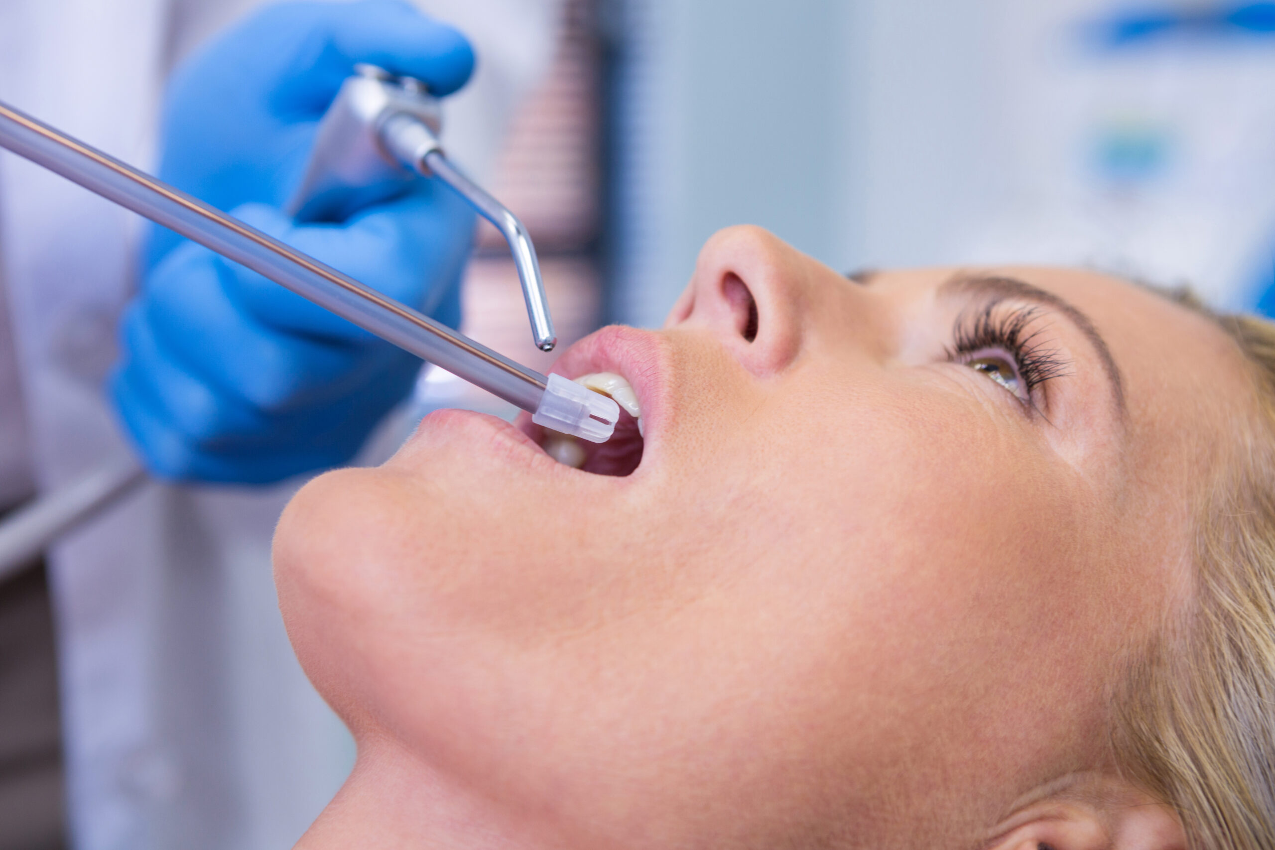 extreme-close-up-of-dentist-examining-woman