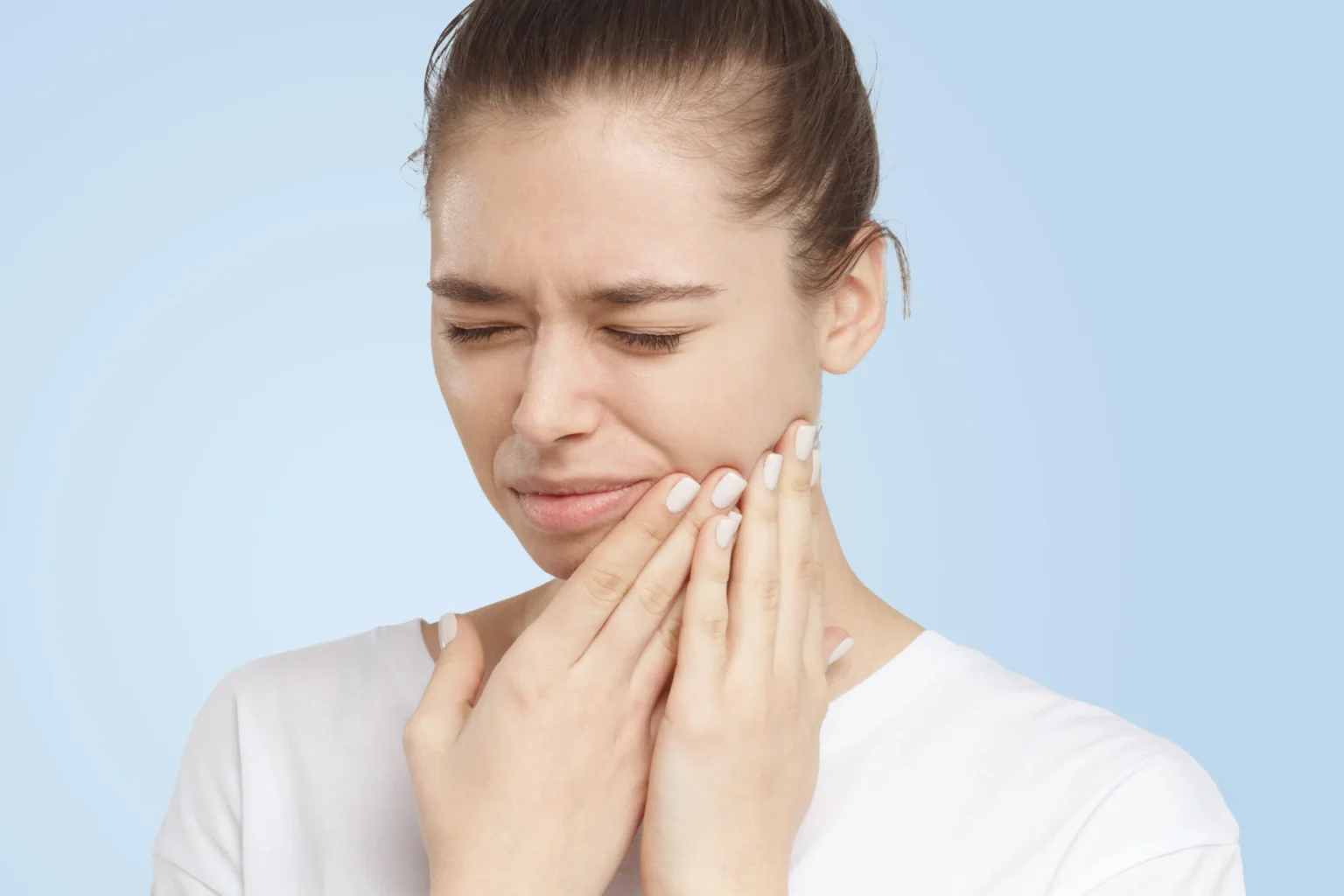 Beautiful woman touching her face and closing eyes with expression of horrible suffer