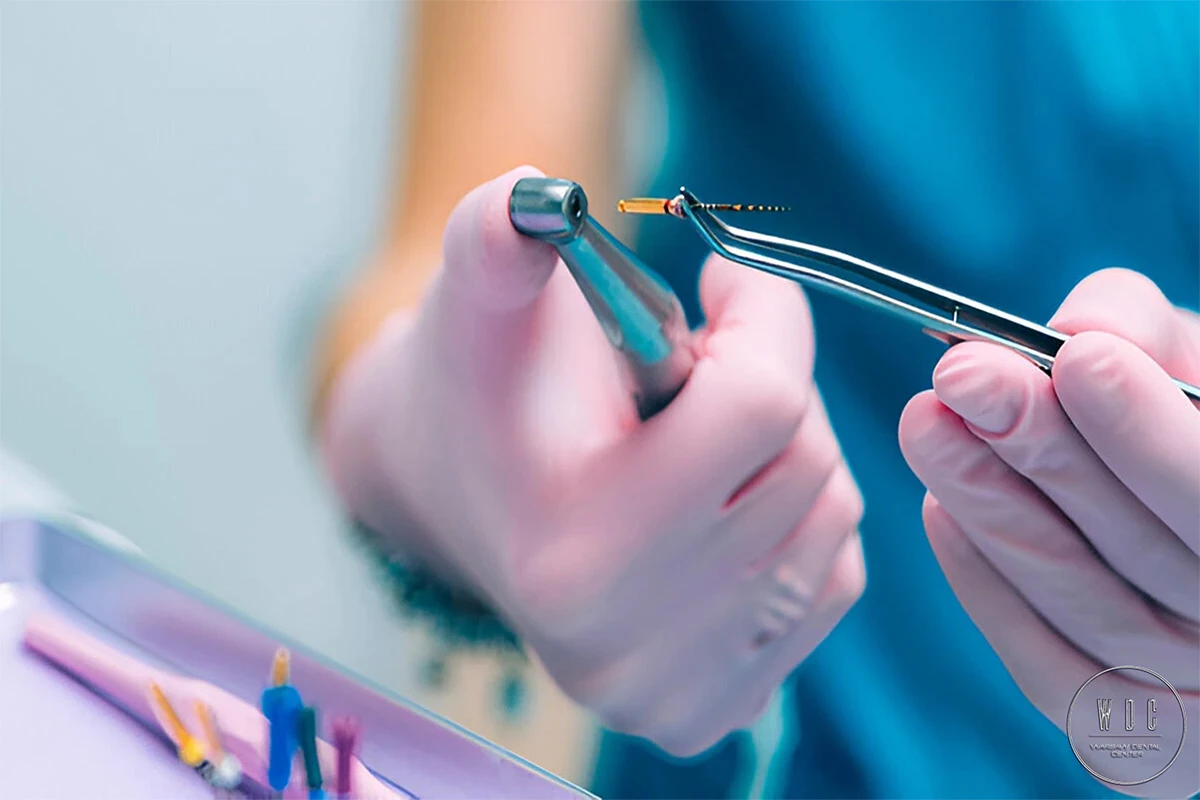 Dentist's hands holding a dental drill before the procedure.