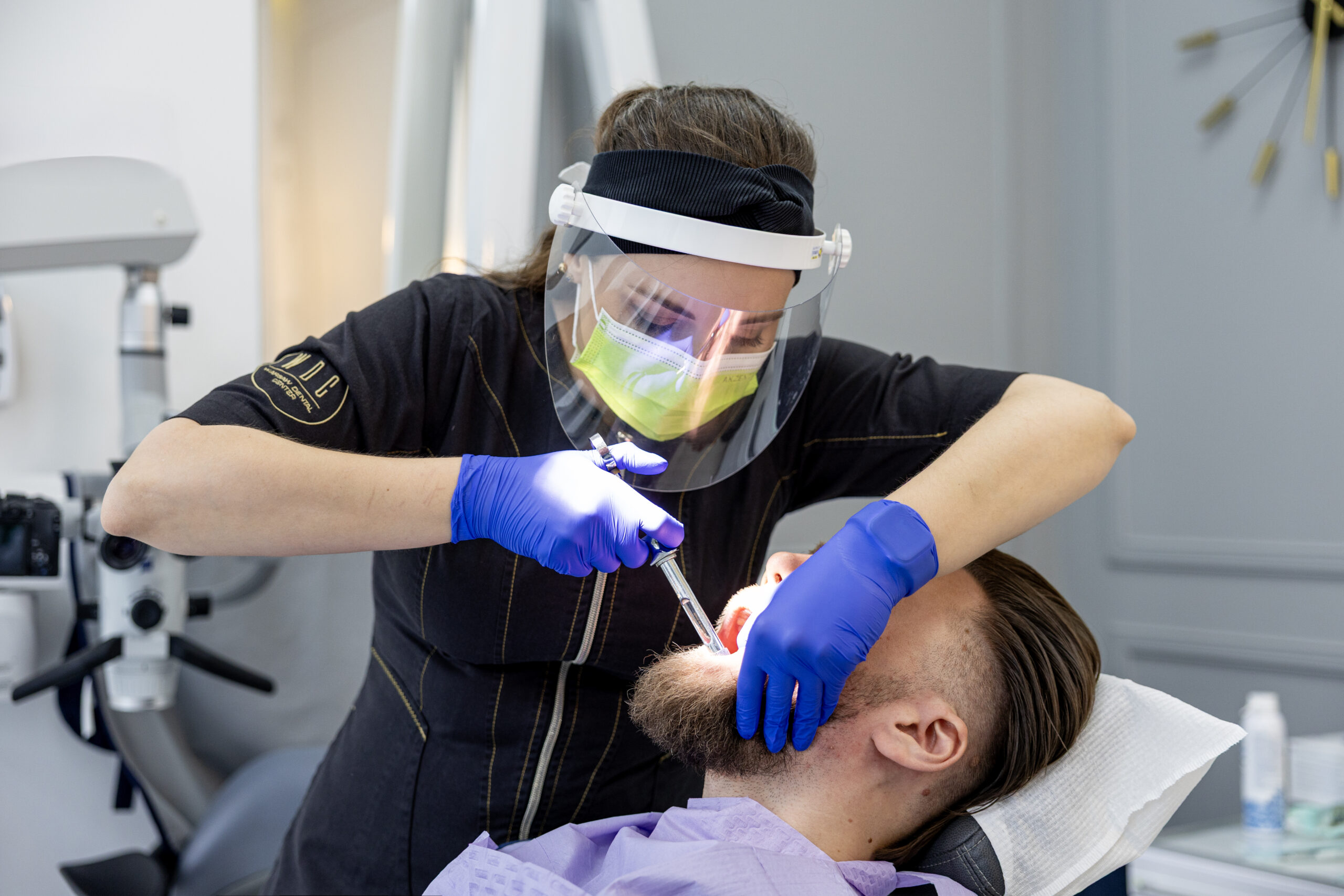 Dr. Natalia Rogulska performing bonding on a patient at Warsaw Dental Center