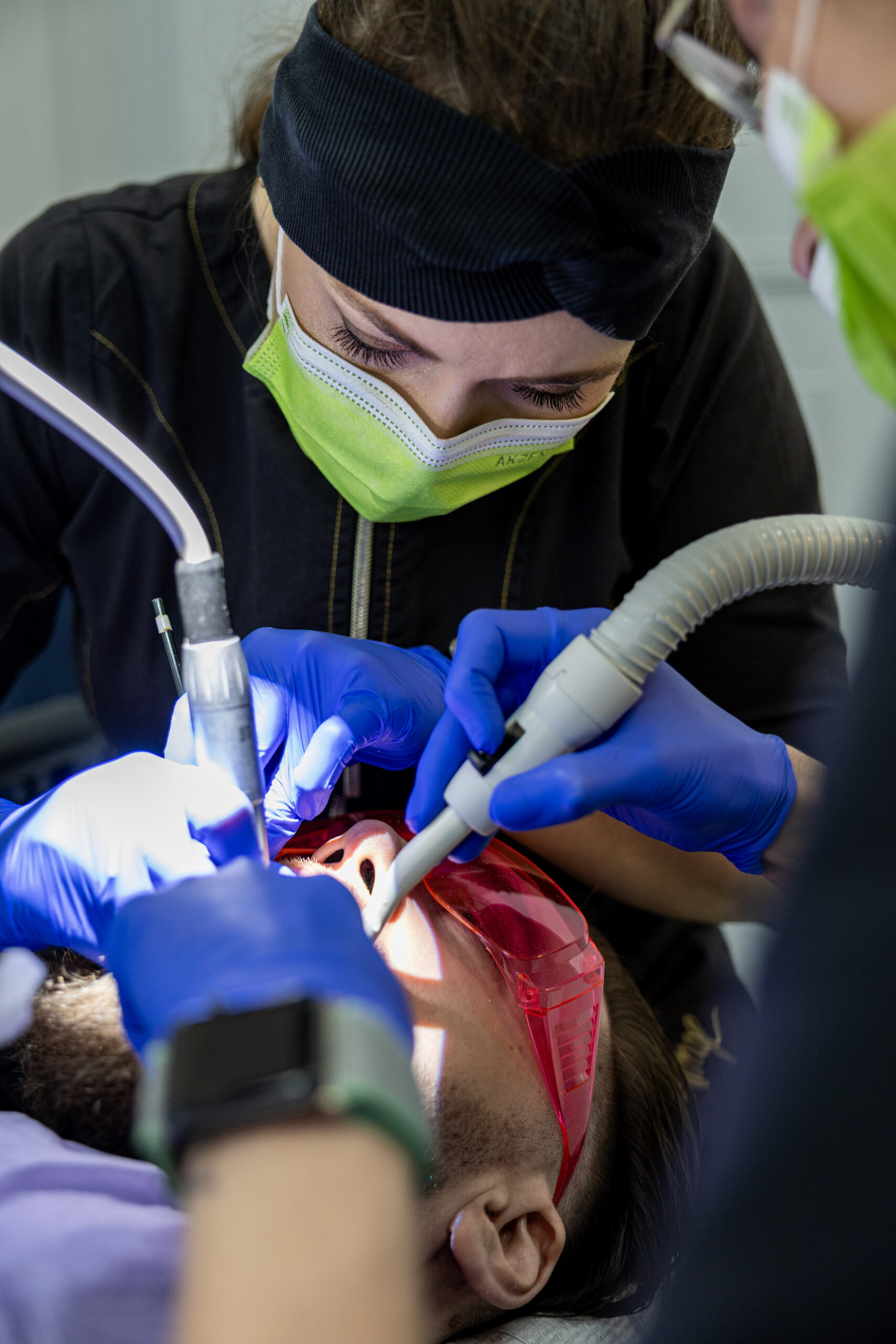 Dr. Natalia Rogulska performing a precise dental procedure on a patient at Warsaw Dental Center