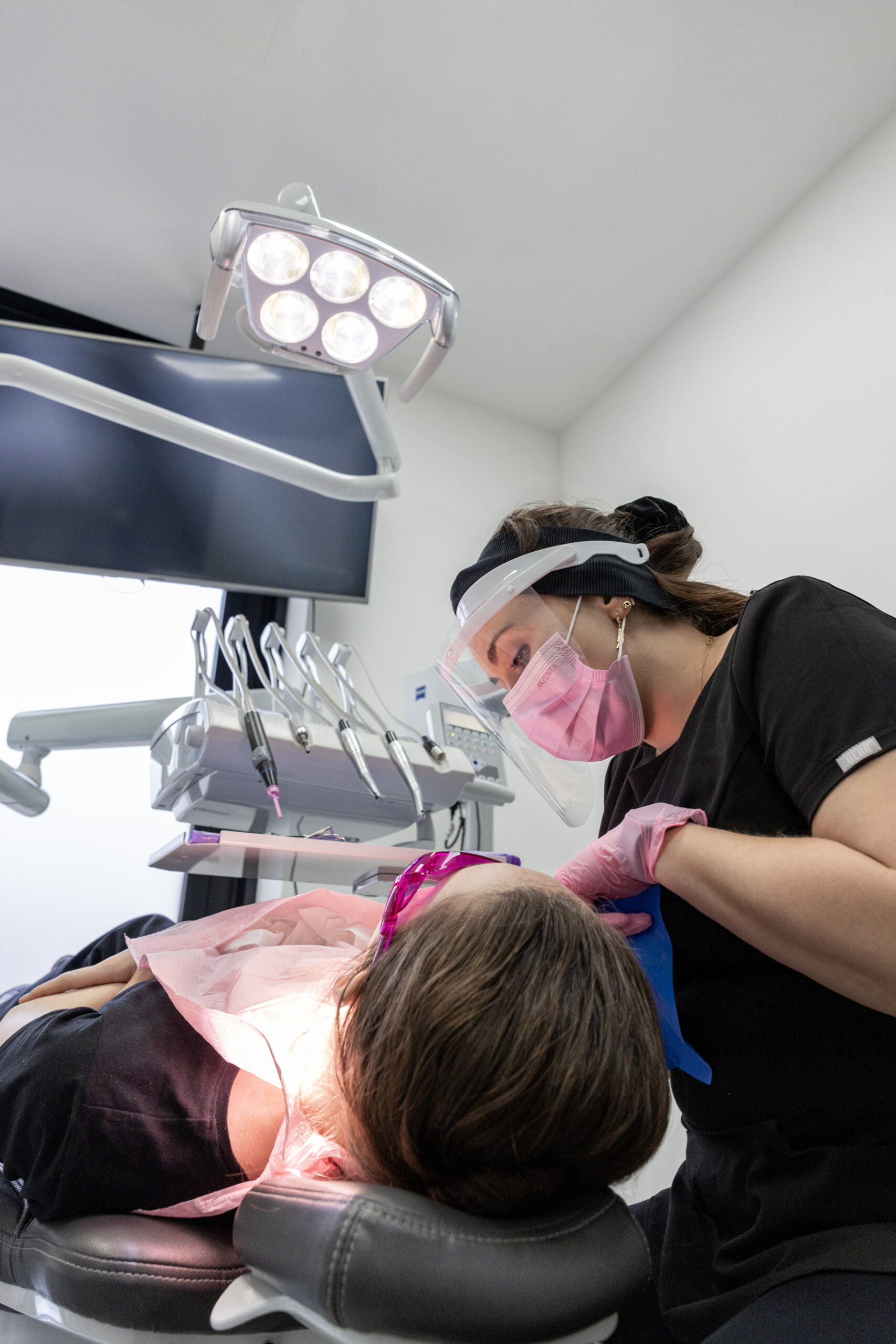 Dr. Natalia Rogulska providing dental care to a patient in a treatment room at Warsaw Dental Center