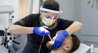 Dr. Natalia Rogulska performing bonding on a patient at Warsaw Dental Center