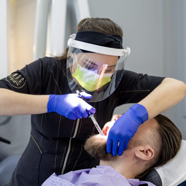 Dr. Natalia Rogulska performing bonding on a patient at Warsaw Dental Center