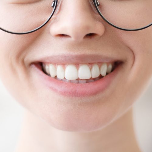 Close up shot of young beautiful woman toothy smile